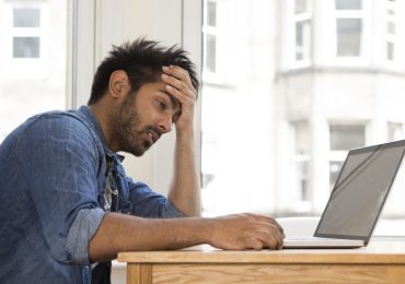 security breach, man frustrated with laptop
