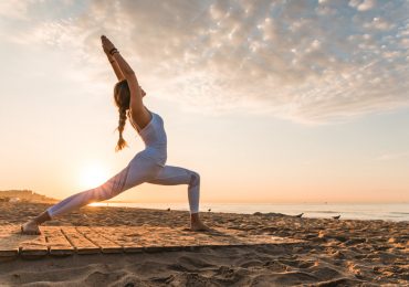 yoga trends, girl doing yoga on the beach