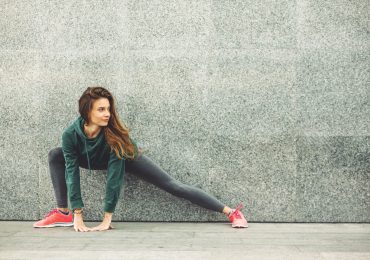 2019 fitness trends, woman stretching after a work out