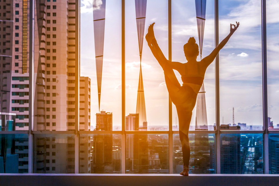 yoga studio marketing ideas, Woman practicing yoga on city view