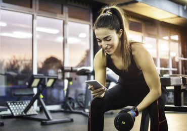 online gym software, woman at gym on the phone