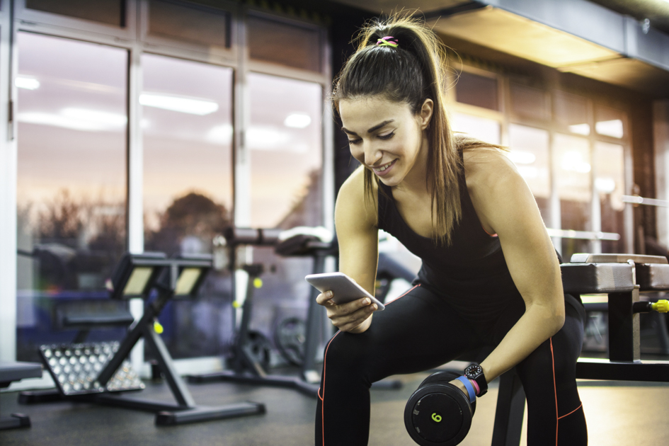 online gym software, woman at gym on the phone