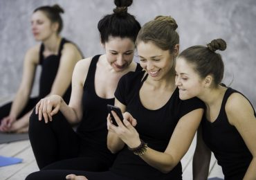yoga studio social media, yogis checking phone