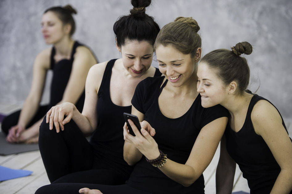 yoga studio social media, yogis checking phone