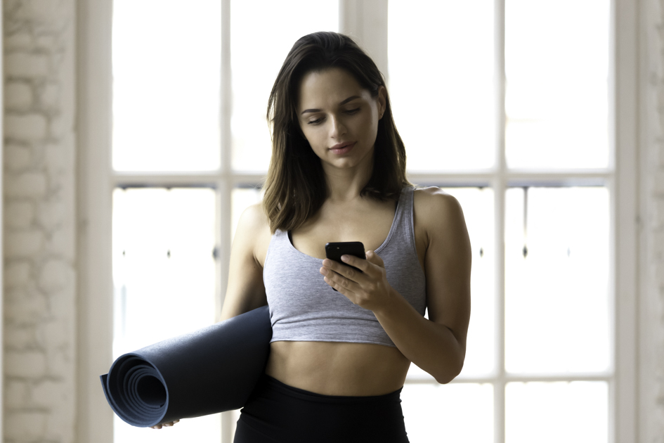 pilates studio app, pilates instructor on phone