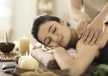 client retention plan, Young woman receiving massage in spa salon