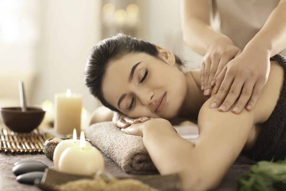 client retention plan, Young woman receiving massage in spa salon