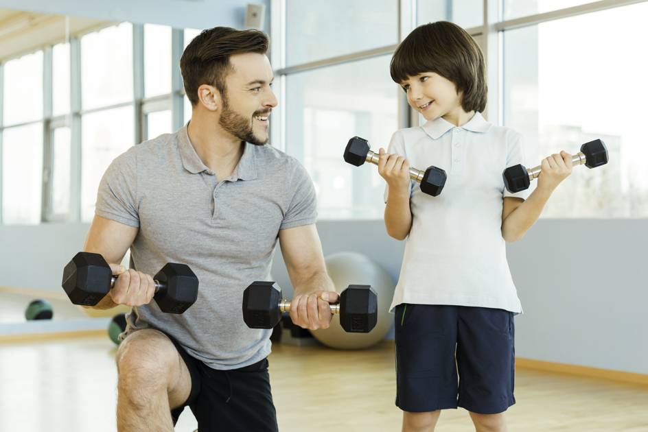 gym for children, young boy and personal trainer