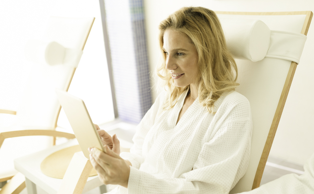 wellness center social media, woman checking phone