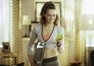 Social media personal trainer, personal trainer on her phone