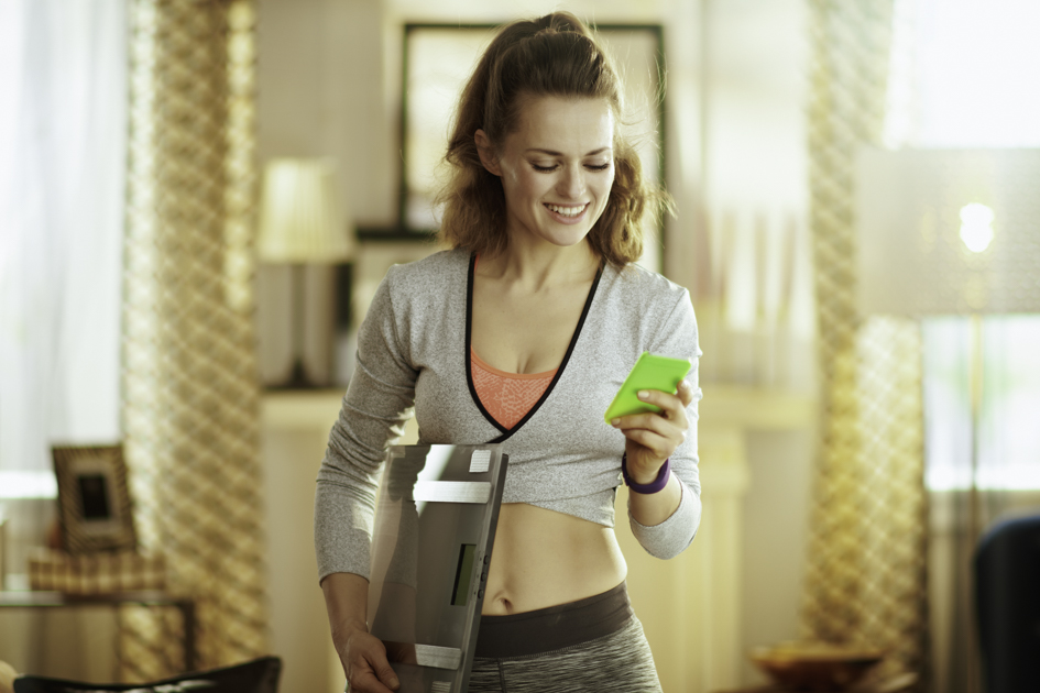 Social media personal trainer, personal trainer on her phone