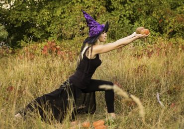 Halloween yoga marketing, woman practicing yoga in Halloween costume