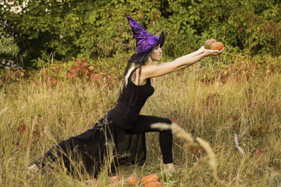 Halloween yoga marketing, woman practicing yoga in Halloween costume