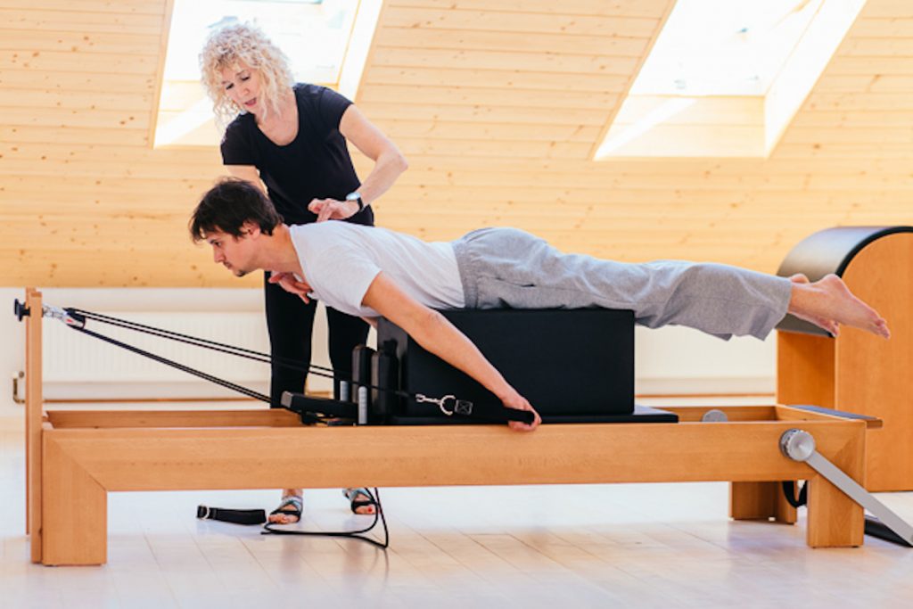 Pilates instructor, Pilates instructor with client