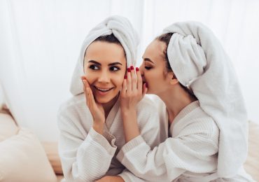 upselling techniques, two women whispering in spa