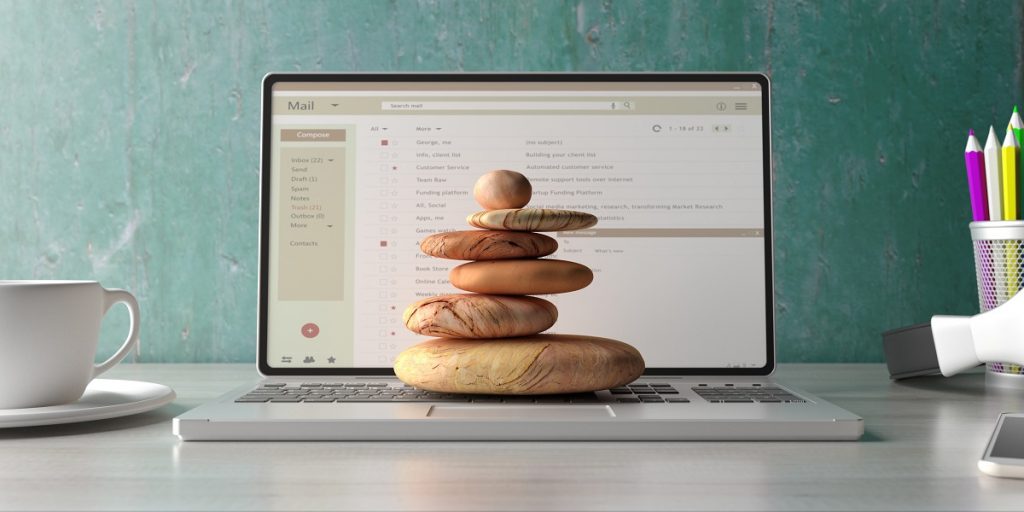 wellness booking software, stones on laptop