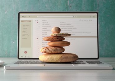 wellness booking software, stones on laptop