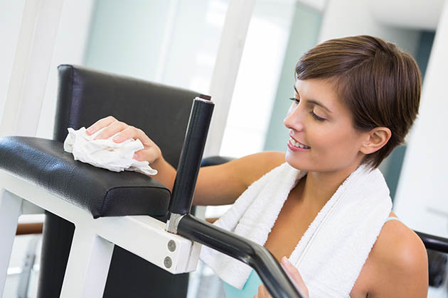 cleaning strategy, fit brunette wiping down bench