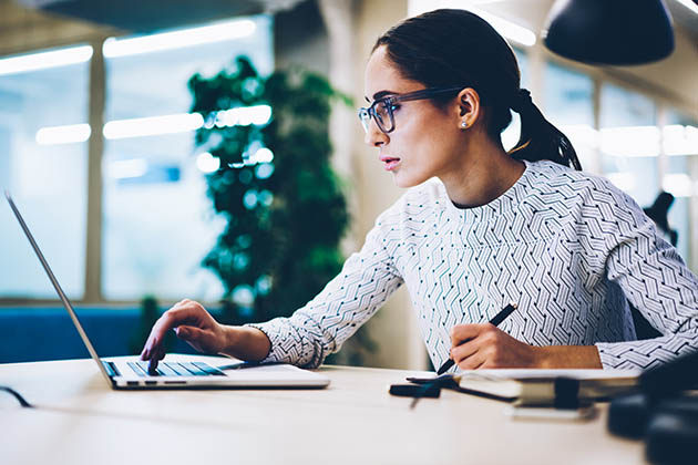 protect your business, serious female at computer