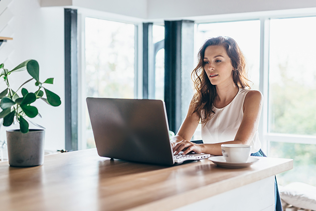 time management strategies, woman using laptop while sitting at home