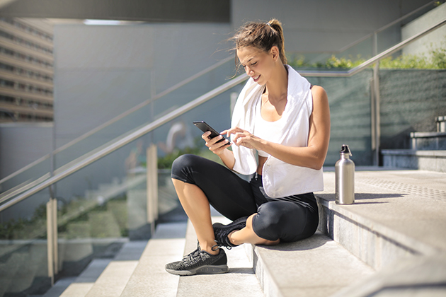 automated marketing, sporty girl taking a break with her phone