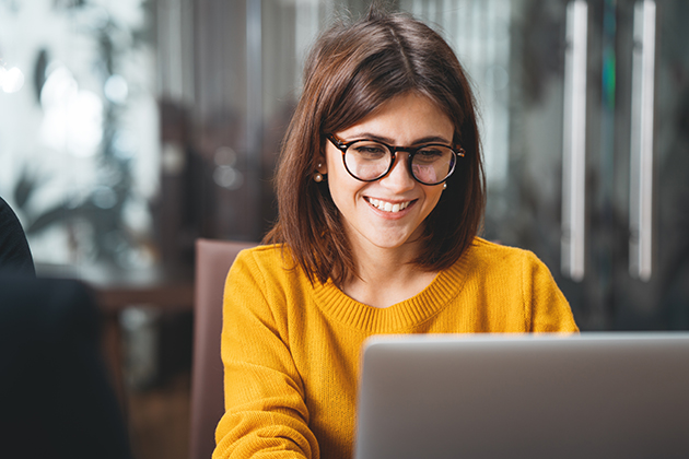 direct mail marketing, happy business woman at a computer