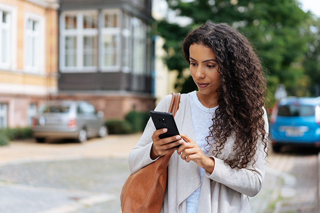 new clients, young woman looking at her phone