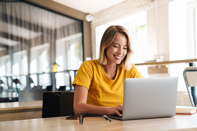 managing memberships, joyful nice woman using laptop and smiling