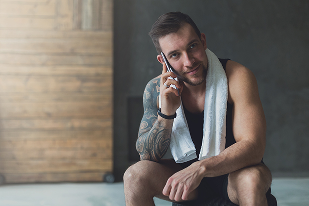 managing memberships, handsome man call mobile phone in gym