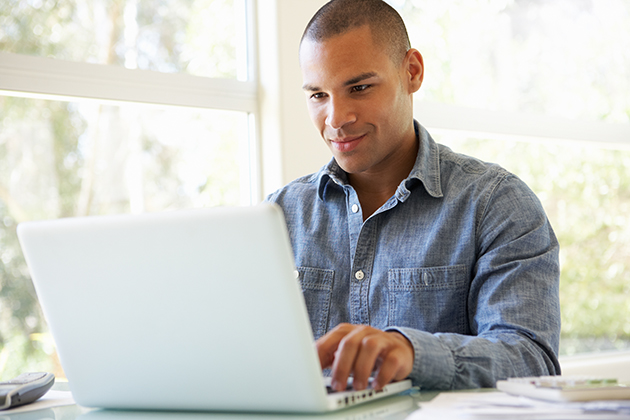 martial arts studio, young man using laptop at home