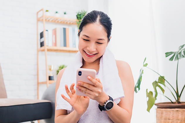 multiple closures, Asian woman using smartphone after play yoga and exercise at home