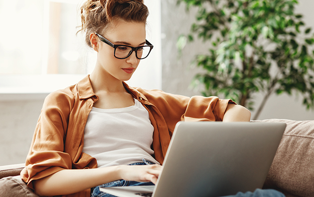 yoga studio, woman using laptop on sofa