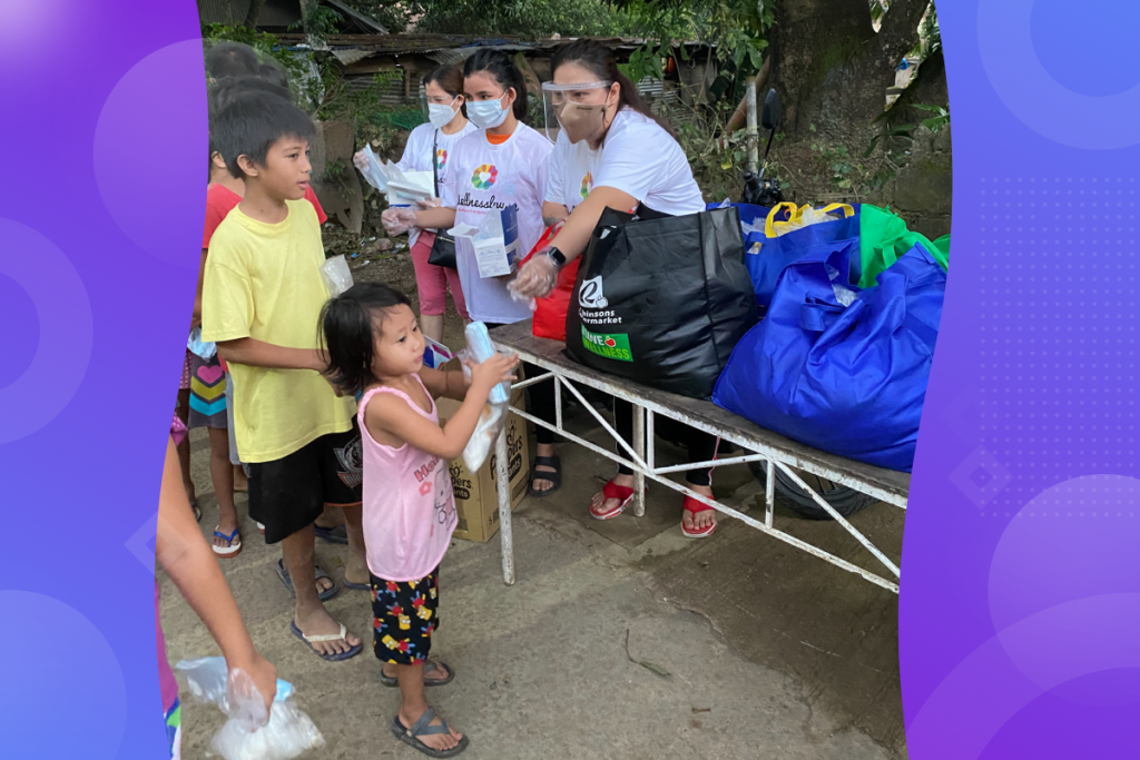 typhoon relief, WellnessLiving team distributing supplies
