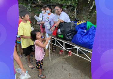 typhoon relief, WellnessLiving team distributing supplies