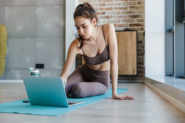 increase profits, young athletic woman using laptop while working out