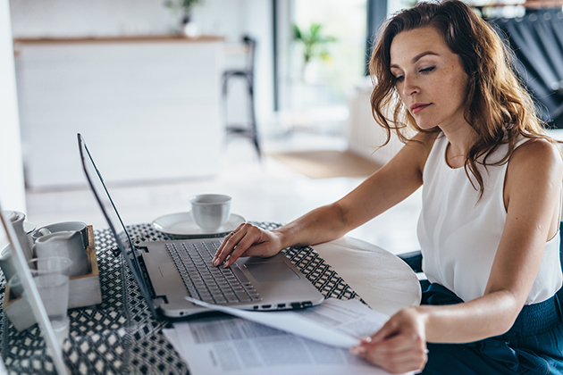 types of insurance, woman using laptop while sitting at table