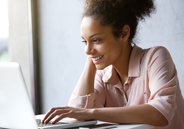 manage clients, beautiful young woman smiling and looking at laptop screen