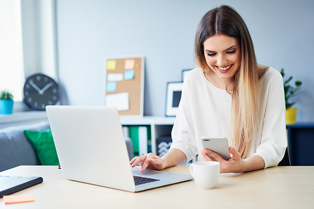 market your business, cheerful young woman working on phone and laptop in home office