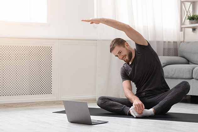 increasing revenue, young man practicing fitness with online training on laptop
