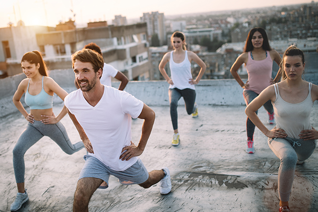 licensing or franchising, group of fit healthy friends, people exercising together outdoor on rooftop