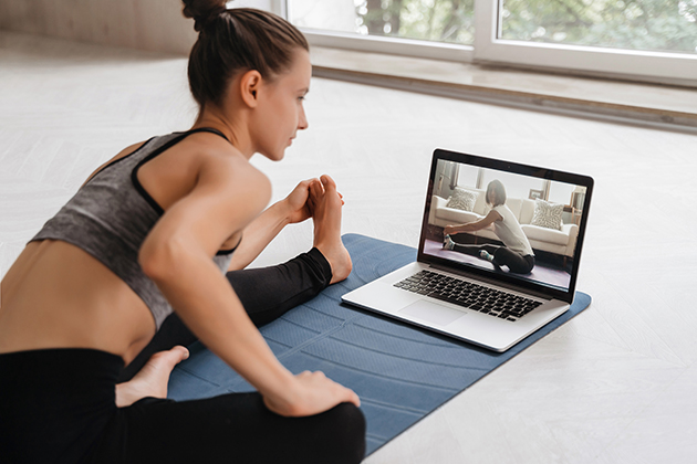 customer relationships, young woman practicing yoga at home on video conference