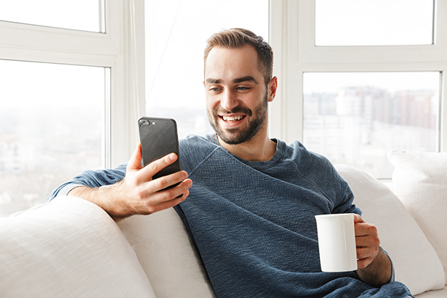 New Year's resolution, attractive young man relaxing with phone