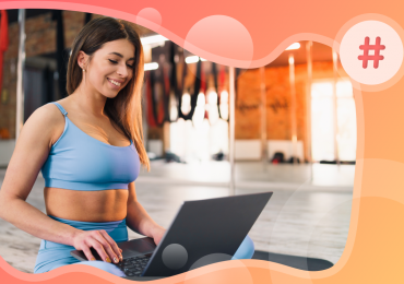 attract new members to your fitness business, woman at her computer