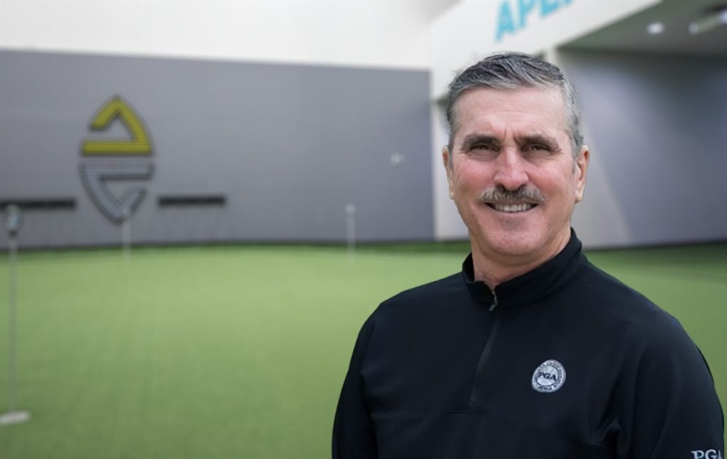 Owner of Altura Golf standing on indoor golf green