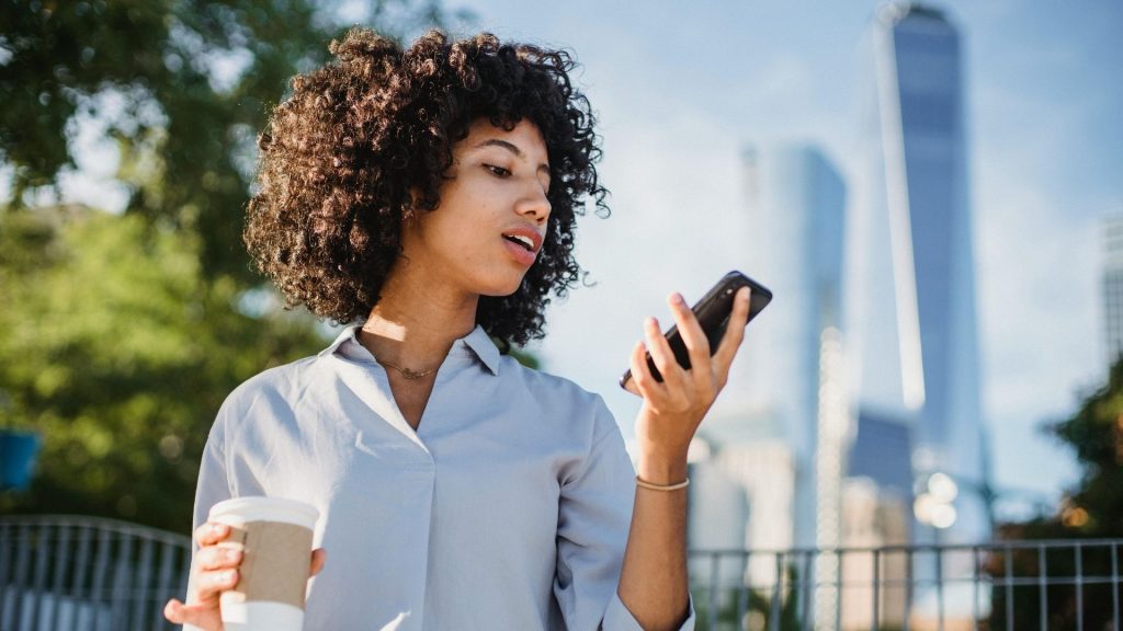 Young person looking at a rewards notification from their favorite coffee shop.