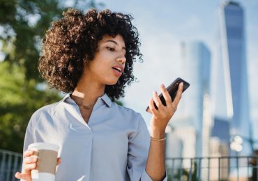 Young person looking at a rewards notification from their favorite coffee shop.
