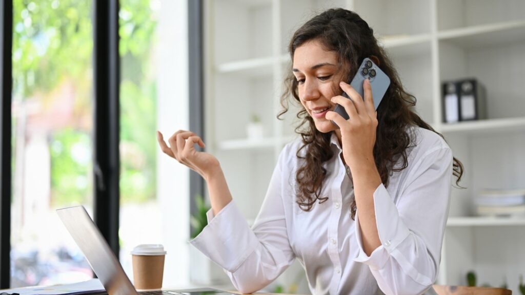 A woman makes an appointment with a virtual receptionist during her busy work day.