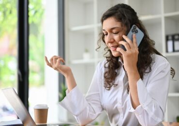 A woman makes an appointment with a virtual receptionist during her busy work day.