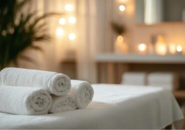Rolled towels ready on a massage table in a busy med spa.