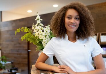 A spa owner smiling proudly on the opening day of her new spa.